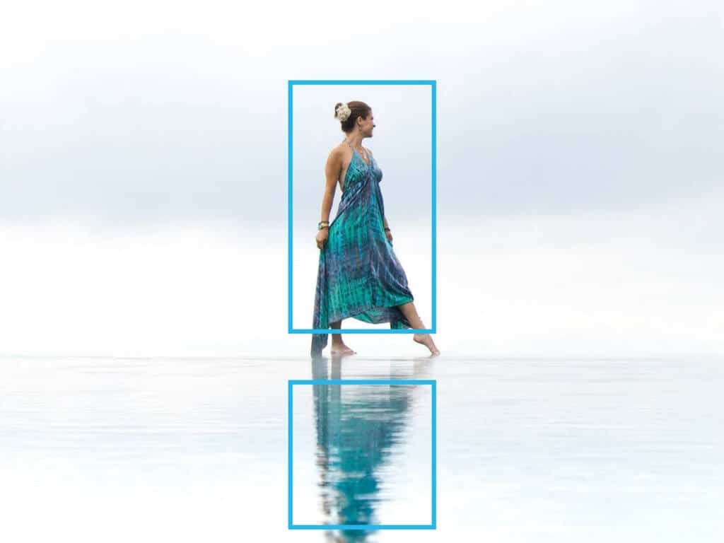 A girl standing on the edge of an infinity pool with her reflection in the water. Using these travel photography composition tips, your images will look just as astounding as the places you visit! Discover all you need to know for jaw-dropping photos! And for more travel tips and wanderlust inspiration follow The Scenic Suitcase on Pinterest!
