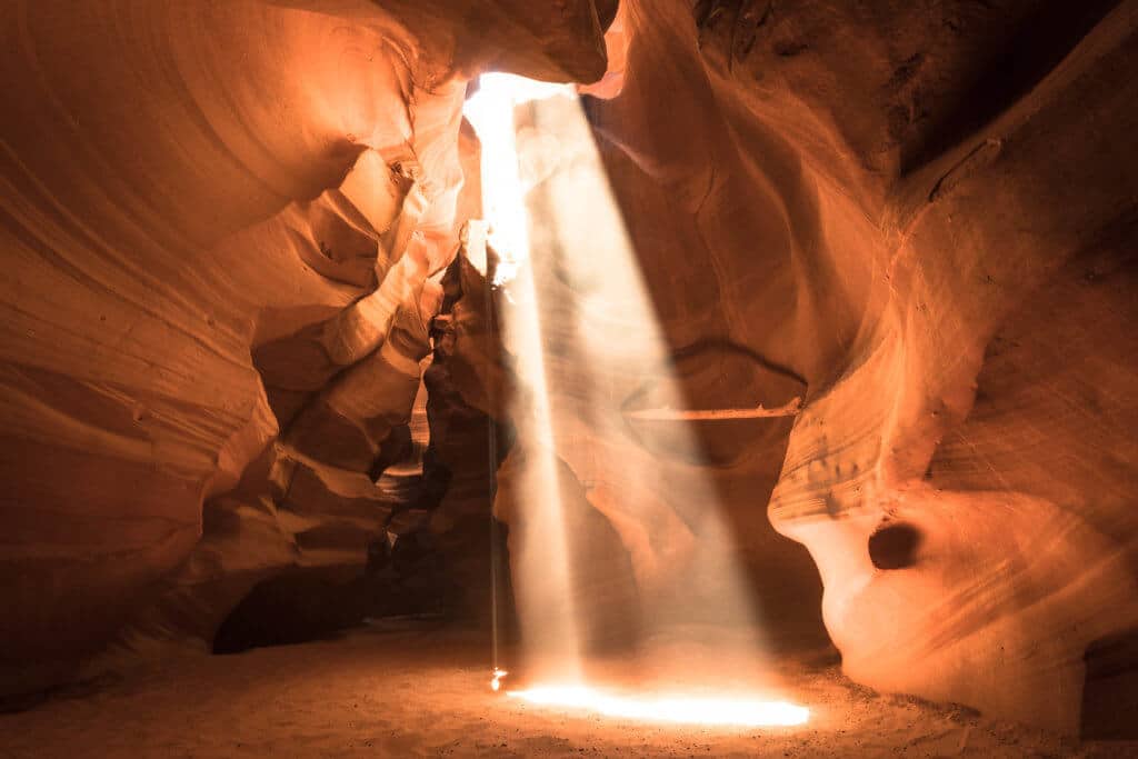 A sun beam lighting up the walls of Antelope Canyon. A girl with a suitcase walking down a road near Monument Valley. Discover 20 of the most iconic photo locations in the world, with links to a map of where you can find them! And for more wanderlust inspiration and travel tips, follow The Scenic Suitcase on Pinterest!