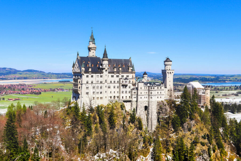 The white and blue Neuschwanstein Castle on a mountain hill overlooking a lake. Discover 20 of the most iconic photo locations in the world, with links to a map of where you can find them! And for more wanderlust inspiration and travel tips, follow The Scenic Suitcase on Pinterest!