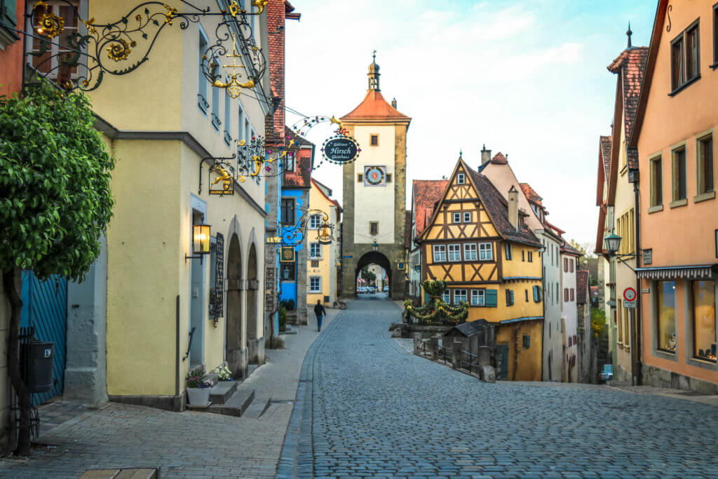 A cobblestone street with half-timbered facades and a stone archway. Discover 20 of the most iconic photo locations in the world, with links to a map of where you can find them! And for more wanderlust inspiration and travel tips, follow The Scenic Suitcase on Pinterest!