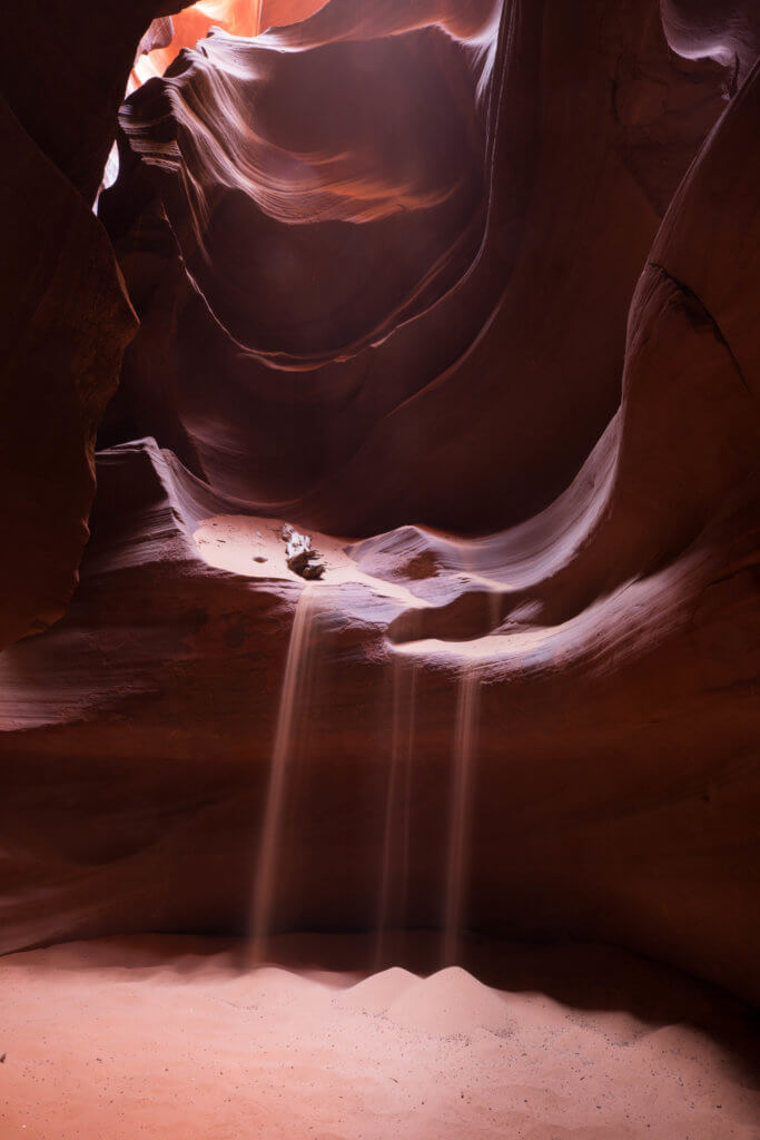 Sand falling inside Antelope Canyon. Discover the very best way to photograph Antelope Canyon. From what tour to book, to the camera settings needed for perfect pictures. And for more travel tips and wanderlust inspiration, follow The Scenic Suitcase on Pinterest!
