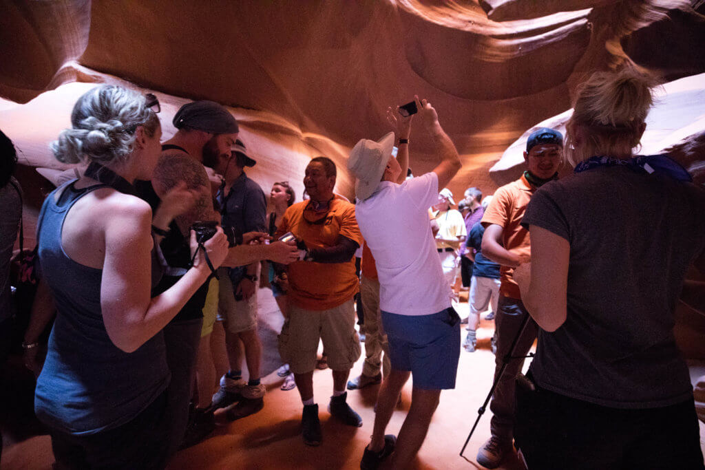 Lots and lots of people inside Antelope Canyon. Discover the very best way to photograph Antelope Canyon. From what tour to book, to the camera settings needed for perfect pictures. And for more travel tips and wanderlust inspiration, follow The Scenic Suitcase on Pinterest!