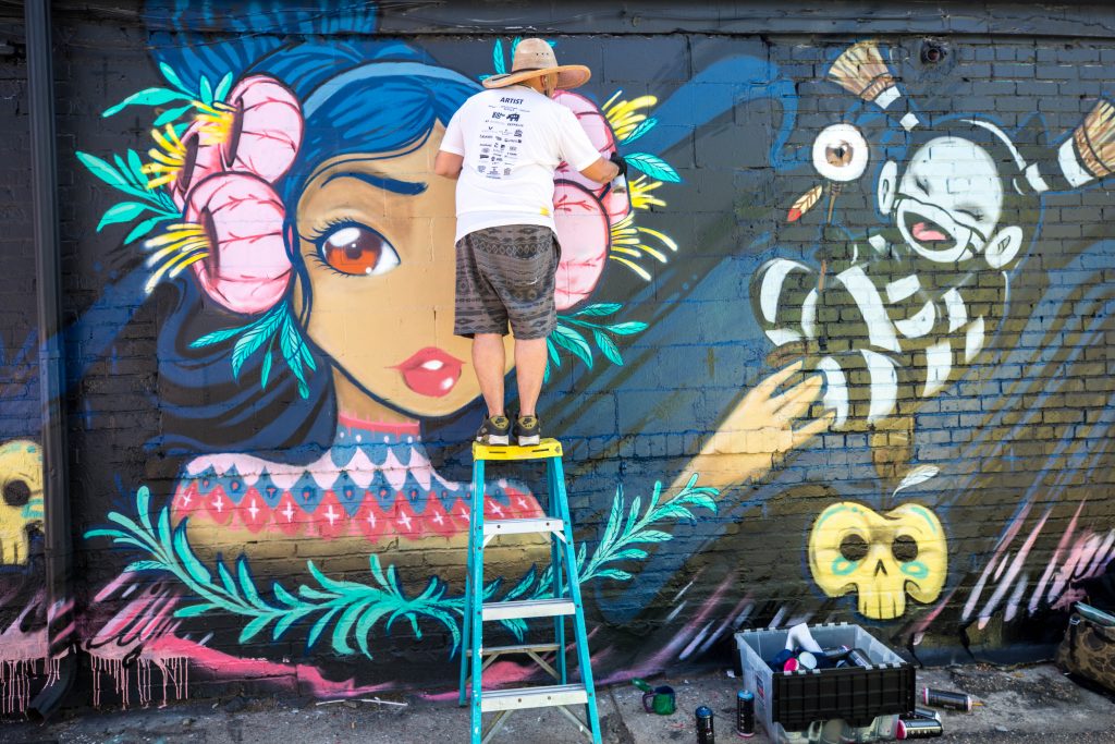 Street artist painting in Denver, Colorado.
