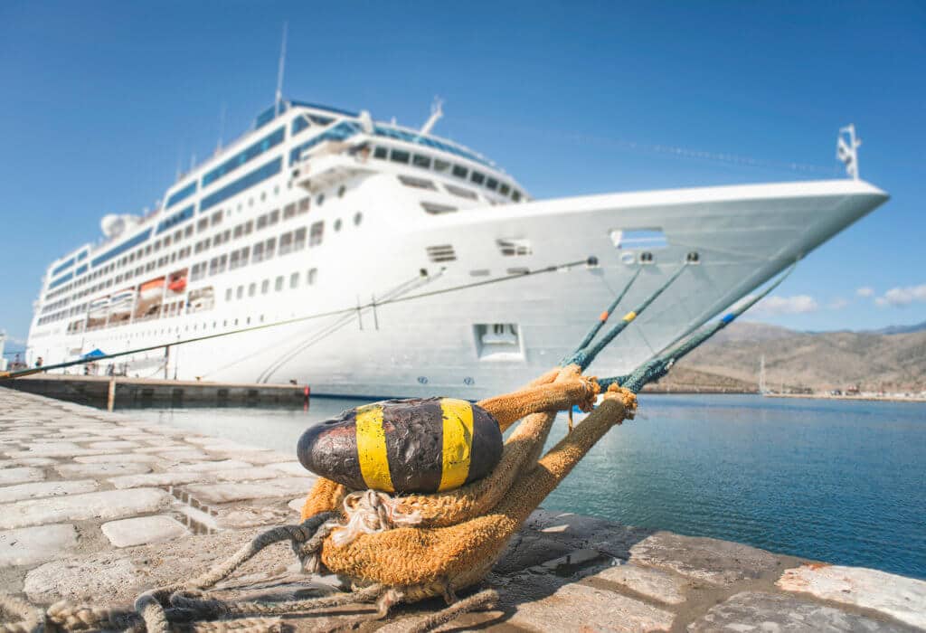 A cruise ship tied at port. There are a lot of different types of vacations out there, so which is right for you? Find out with this comprehensive list of pros and cons! And for more travel tips and wanderlust inspiration follow The Scenic Suitcase on Pinterest!