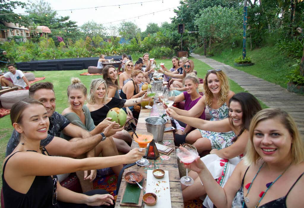 A group cheersing in Bali. There are a lot of different types of vacations out there, so which is right for you? Find out with this comprehensive list of pros and cons! And for more travel tips and wanderlust inspiration follow The Scenic Suitcase on Pinterest!