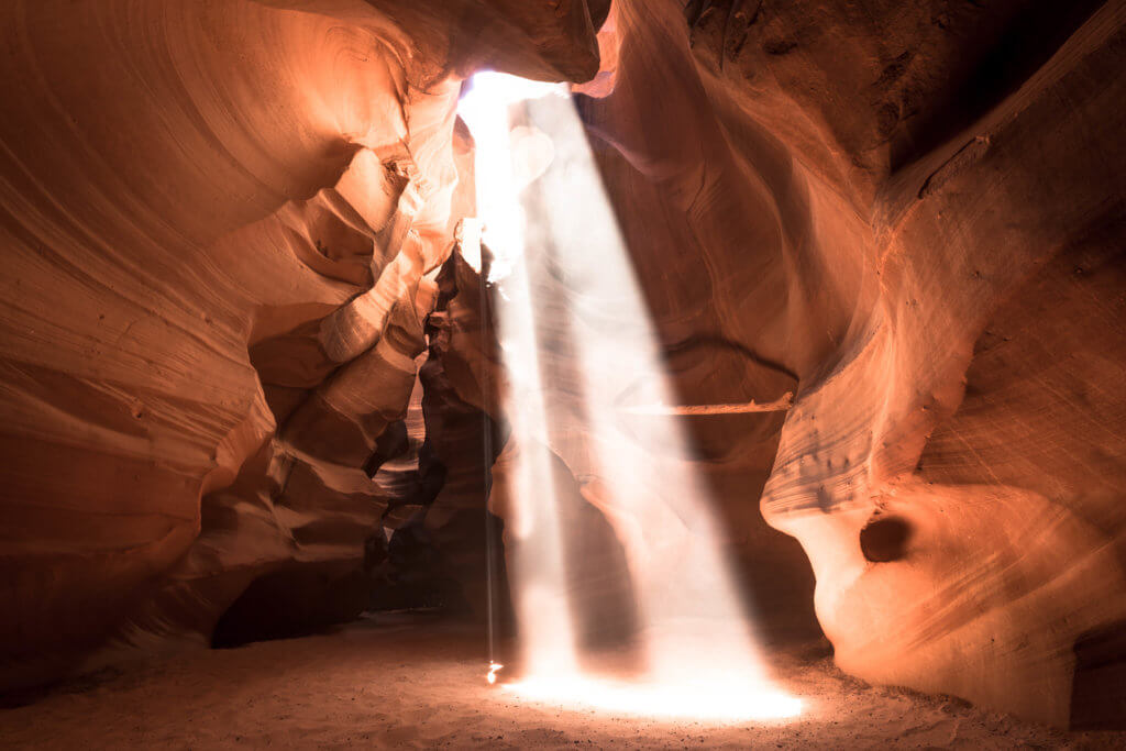 A sun ray inside Antelope Canyon. Discover some of the most beautiful places in the American Southwest. Awe-inspiring destinations and what you shouldn't miss on your next road trip! And for more travel tips and wanderlust inspiration, follow The Scenic Suitcase on Pinterest!