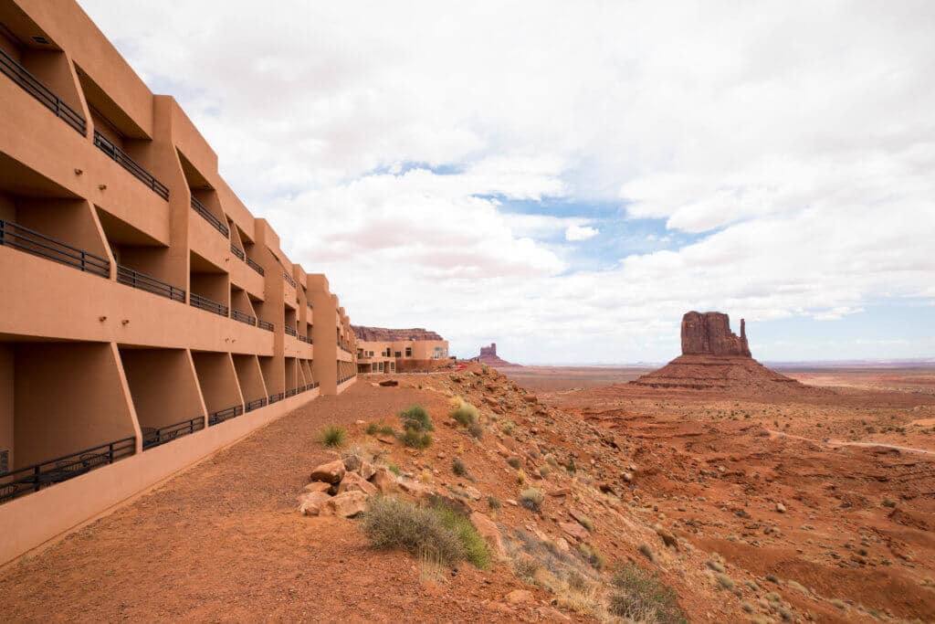The View Hotel overlooking rock formations in Monument Valley. Discover some of the most beautiful places in the American Southwest. Awe-inspiring destinations and what you shouldn't miss on your next road trip! And for more travel tips and wanderlust inspiration, follow The Scenic Suitcase on Pinterest!