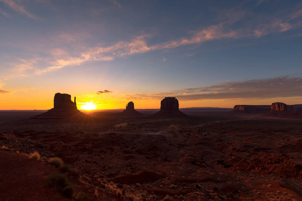 Sunrise in Monument Valley. Discover some of the most beautiful places in the American Southwest. Awe-inspiring destinations and what you shouldn't miss on your next road trip! And for more travel tips and wanderlust inspiration, follow The Scenic Suitcase on Pinterest!