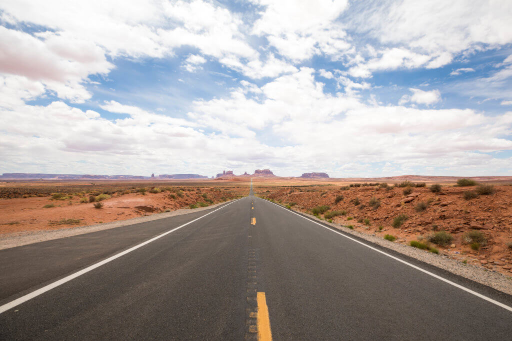 A long stretch of road towards Monument Valley (featured in Forrest Gump). Discover some of the most beautiful places in the American Southwest. Awe-inspiring destinations and what you shouldn't miss on your next road trip! And for more travel tips and wanderlust inspiration, follow The Scenic Suitcase on Pinterest!