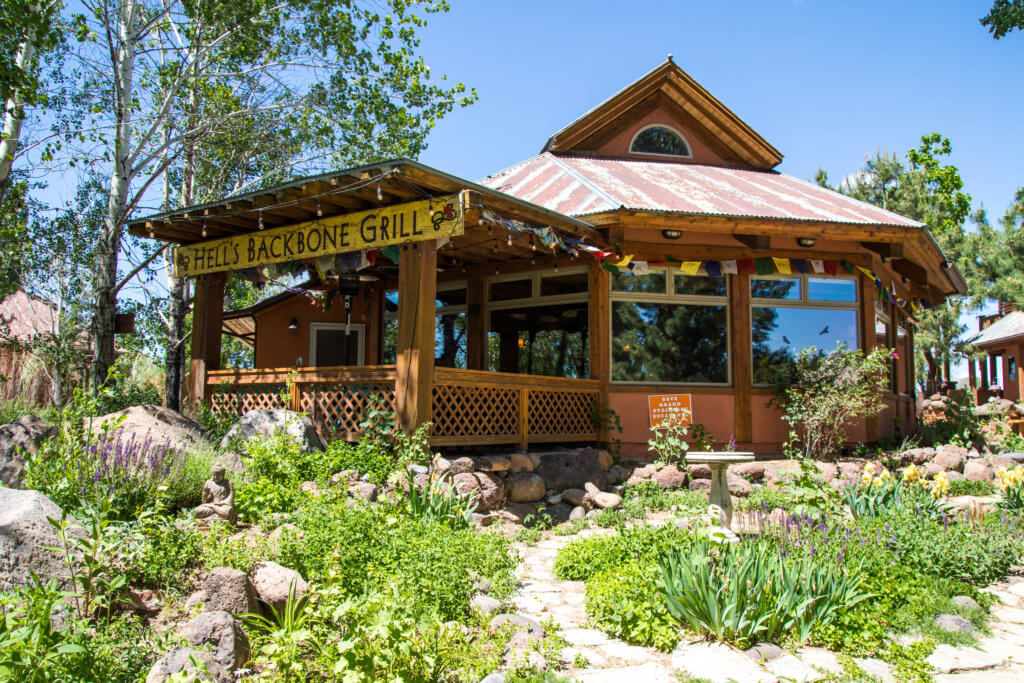 Hell's Backbone Grill surrounded by greenery. Discover some of the most beautiful places in the American Southwest. Awe-inspiring destinations and what you shouldn't miss on your next road trip! And for more travel tips and wanderlust inspiration, follow The Scenic Suitcase on Pinterest!