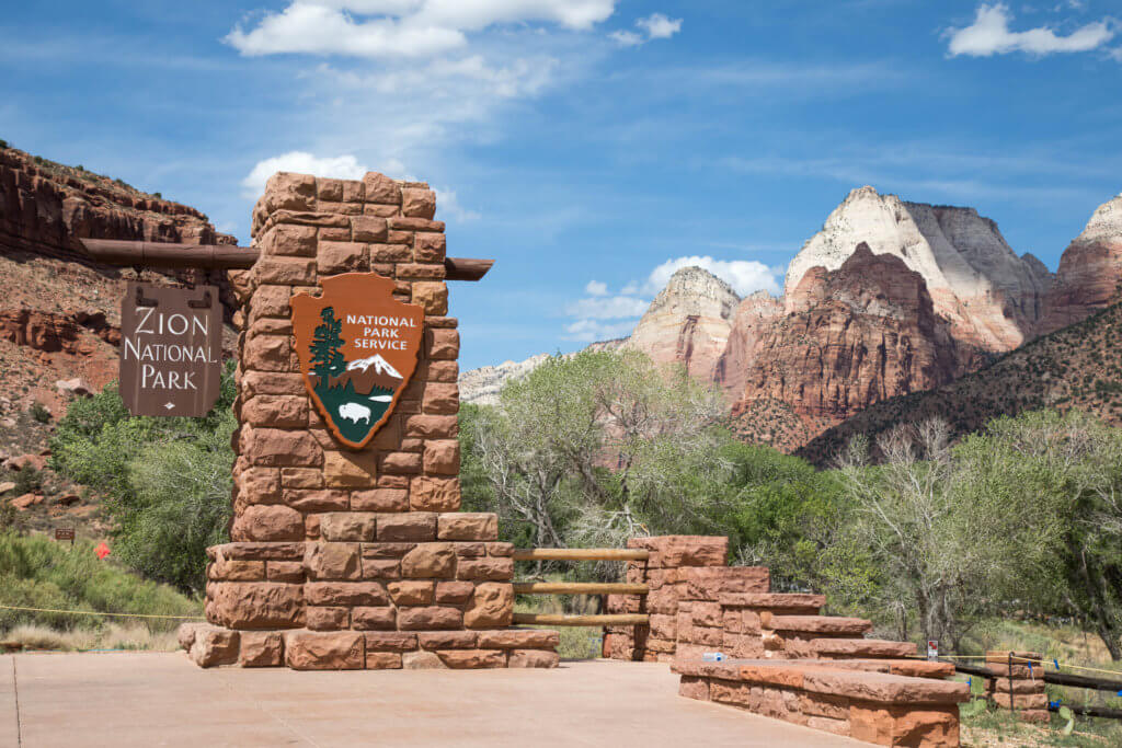 The Zion National Park welcome sign. Discover some of the most beautiful places in the American Southwest. Awe-inspiring destinations and what you shouldn't miss on your next road trip! And for more travel tips and wanderlust inspiration, follow The Scenic Suitcase on Pinterest!