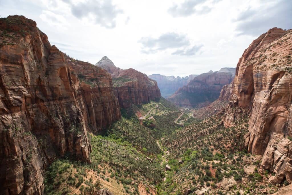 Zion National Park from the top of the Canyon Overlook trail. Discover some of the most beautiful places in the American Southwest. Awe-inspiring destinations and what you shouldn't miss on your next road trip! And for more travel tips and wanderlust inspiration, follow The Scenic Suitcase on Pinterest!