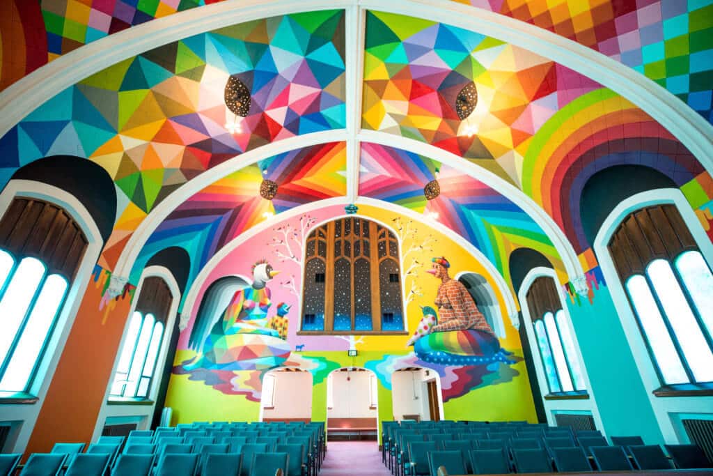 The colorful interior of the International Church of Cannabis. Discover the most stunning, offbeat, and unique places in Colorado. Including cliff diving dinner entertainment, haunted hotels, towering dunes, and more! And for additional travel tips and wanderlust inspiration, follow The Scenic Suitcase on Pinterest!
