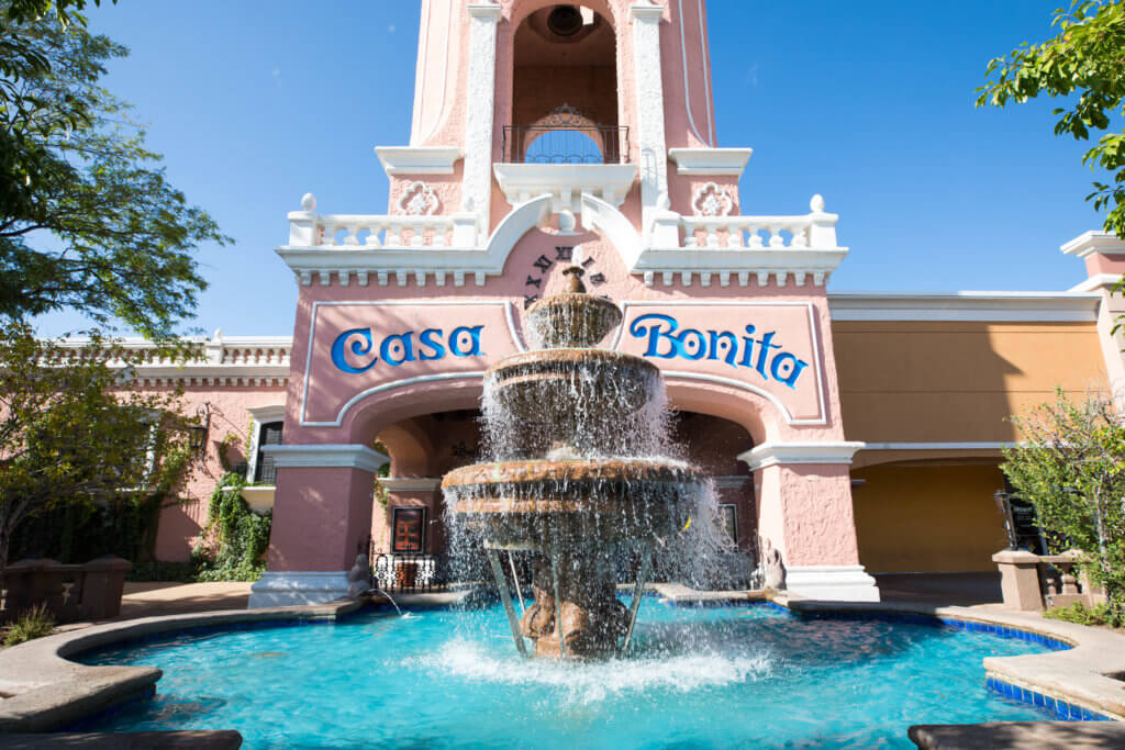 The outside of Casa Bonita near the fountain. Discover the most stunning, offbeat, and unique places in Colorado. Including cliff diving dinner entertainment, haunted hotels, towering dunes, and more! And for additional travel tips and wanderlust inspiration, follow The Scenic Suitcase on Pinterest!
