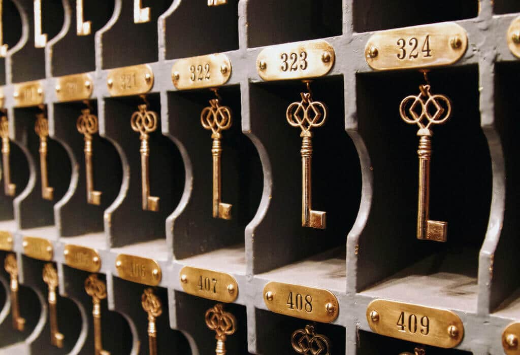 Antique skeleton keys hanging on a hotel front desk. The Stanley Hotel has classic charm, an intriguing past, and otherwordly guests. Discover what it's like to meet ghosts on a Stanley Hotel haunted tour! And for more travel tips and wanderlust inspiration, follow The Scenic Suitcase on Pinterest!