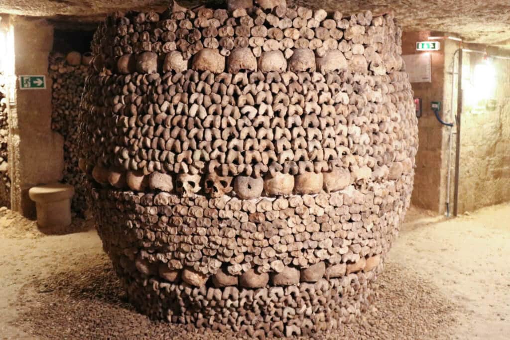 Circular pillar made of human bones. Learn the best tips for visiting the Paris catacombs. How to avoid insanely long lines, and what to expect when you get there! And for more travel tips and wanderlust inspiration follow The Scenic Suitcase on Pinterest!