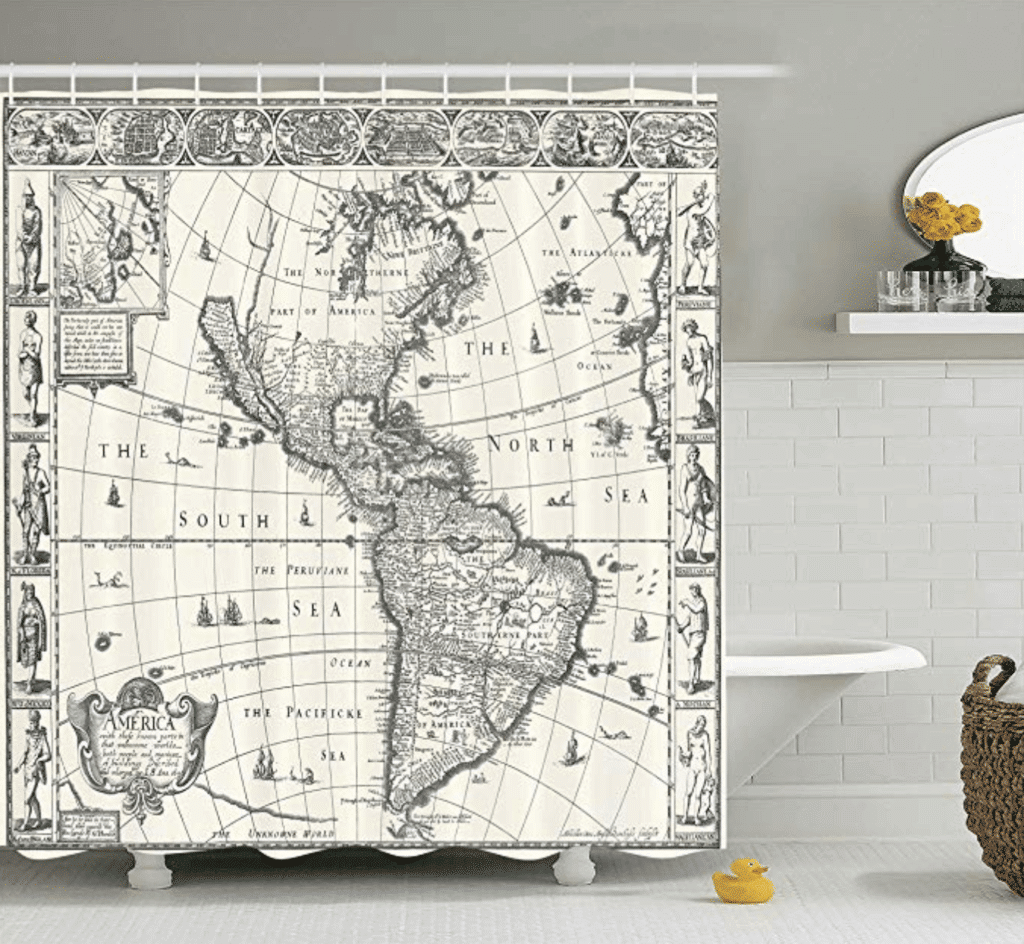 A cream and gray world map shower curtain hanging over a tub near white tiles. Stylish, afforable, and fun travel inspired home decor that's perfect for anyone with a serious case of wanderlust. Find that perfect accent for your home! And for more travel tips and wanderlust inspiration, follow The Scenic Suitcase on Pinterest!