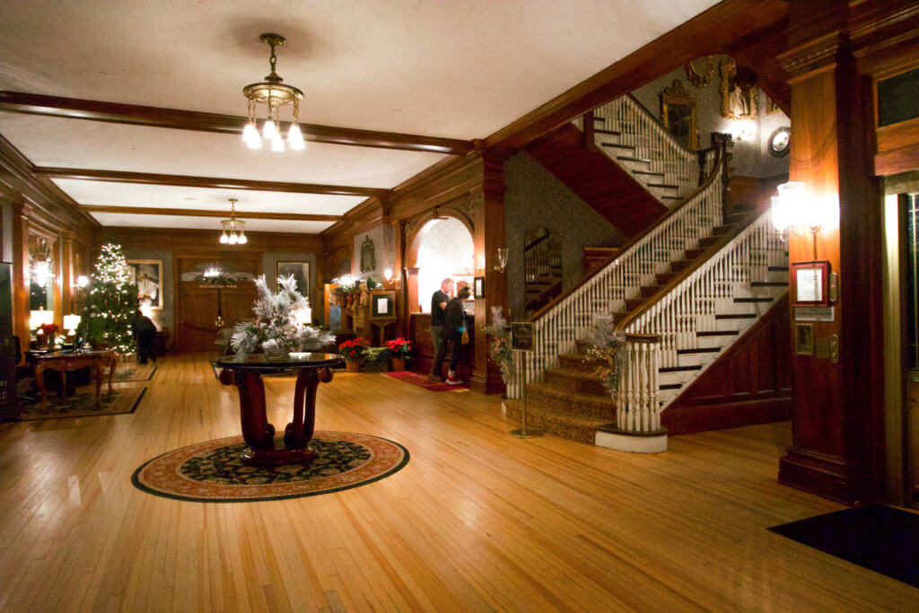 The front lobby of the Stanley Hotel. The Stanley Hotel has classic charm, an intriguing past, and otherwordly guests. Discover what it's like to meet ghosts on a Stanley Hotel haunted tour! And for more travel tips and wanderlust inspiration, follow The Scenic Suitcase on Pinterest!