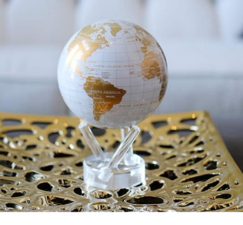 A white and gold Mova globe sitting on a gold tray. Stylish, afforable, and fun travel inspired home decor that's perfect for anyone with a serious case of wanderlust. Find that perfect accent for your home! And for more travel tips and wanderlust inspiration, follow The Scenic Suitcase on Pinterest!
