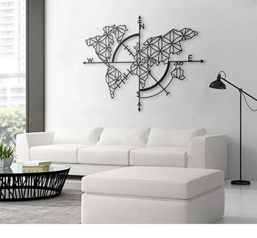 A metal world map with compass hanging above a white couch in a living room. Stylish, afforable, and fun travel inspired home decor that's perfect for anyone with a serious case of wanderlust. Find that perfect accent for your home! And for more travel tips and wanderlust inspiration, follow The Scenic Suitcase on Pinterest!
