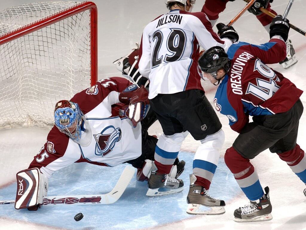 Colorado Avalanche hockey players blocking a goal by the opposing team. Colorado has endless opportunities for fun and adventure. Here are five things to do in Colorado during winter that you really shouldn't miss! And for more travel tips and wanderlust inspiration, follow The Scenic Suitcase on Pinterest!