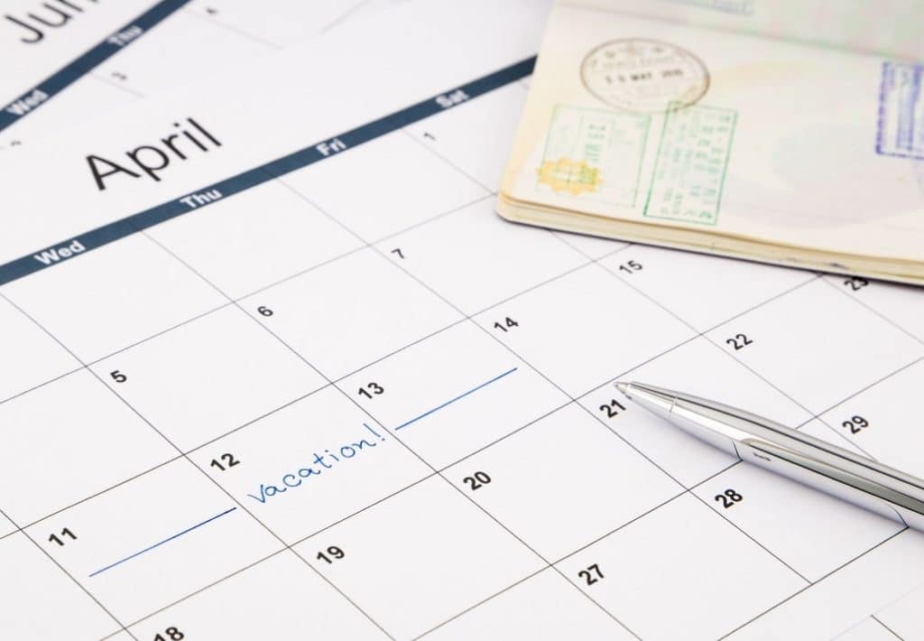 Vacation marked on a calendar near a pen and passport. Holiday travel can become an absolutely nightmare for the unprepared. Instead, use these expert travel tips for holiday travel and save your sanity! And for more travel tips and wanderlust inspiration, follow The Scenic Suitcase on Pinterest!