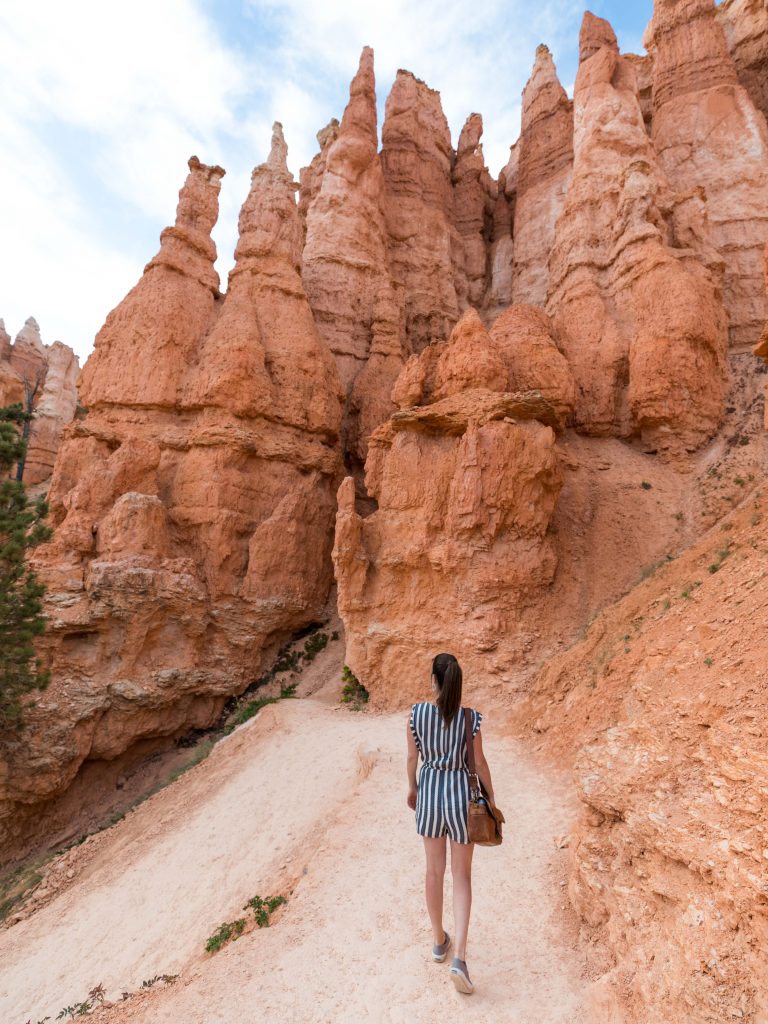 A girl walking along a hiking trail in Bryce Canyon. See the most picture perfect moments of 2018. From London to Cape Town to Las Vegas and more, see what you can't miss in these incredible destinations! And for more travel tips and wanderlust inspiration, follow The Scenic Suitcase on Pinterest!