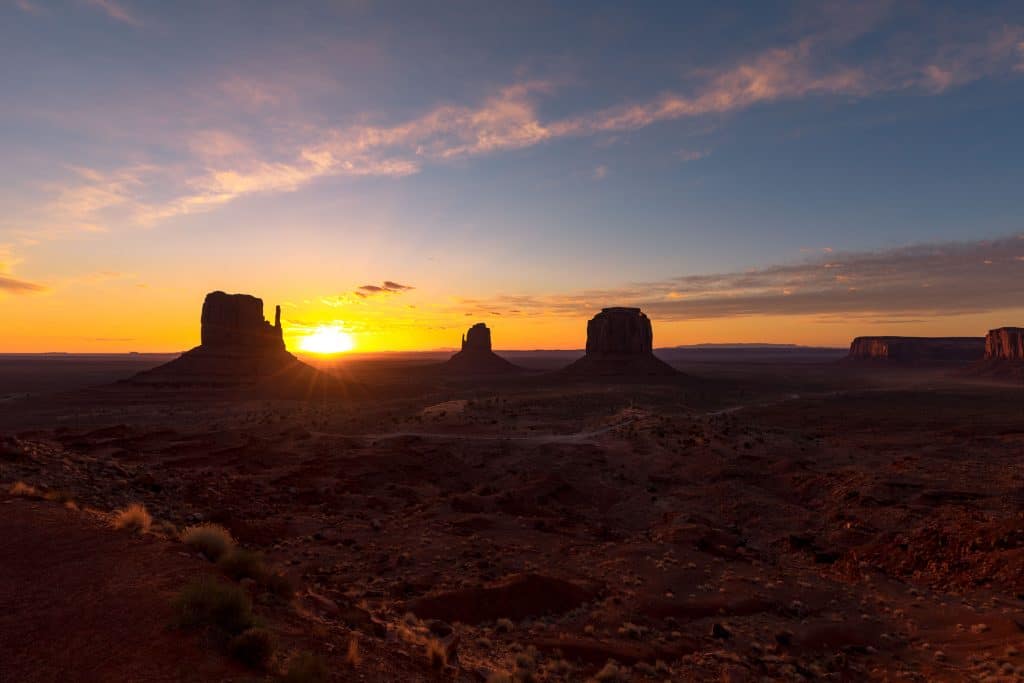 Sunrise over rock formations in Monument Valley. See the most picture perfect moments of 2018. From London to Cape Town to Las Vegas and more, see what you can't miss in these incredible destinations! And for more travel tips and wanderlust inspiration, follow The Scenic Suitcase on Pinterest!