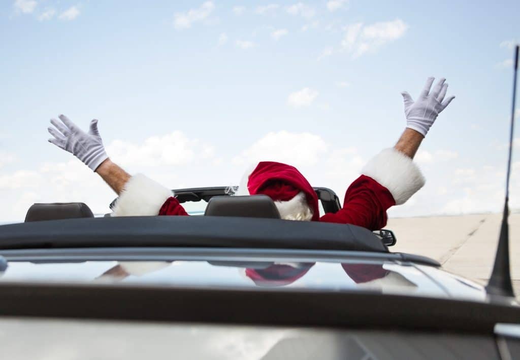 Santa in a convertible with his arms up. Holiday travel can become an absolutely nightmare for the unprepared. Instead, use these expert travel tips for holiday travel and save your sanity! And for more travel tips and wanderlust inspiration, follow The Scenic Suitcase on Pinterest!