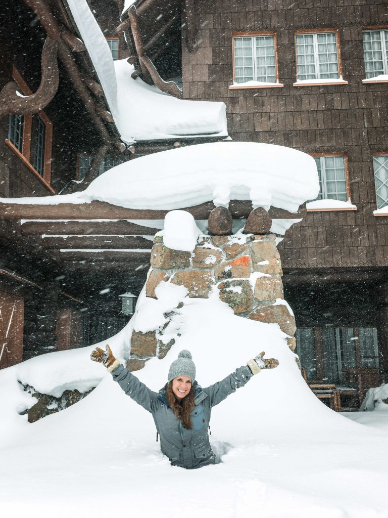 Girl standing in a deep snow drift with her arms up. See the most picture perfect moments of 2018. From London to Cape Town to Las Vegas and more, see what you can't miss in these incredible destinations! And for more travel tips and wanderlust inspiration, follow The Scenic Suitcase on Pinterest!