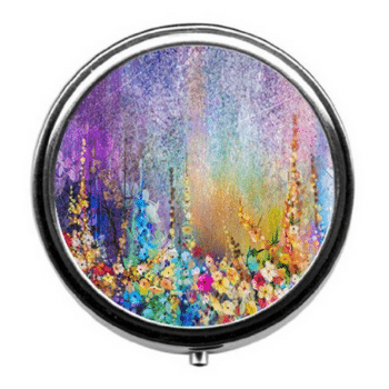 A colorful watercolor pill case. Discover long-haul flight essentials that will make your trip a dream instead of a nightmare. Includes everything you need to enjoy your time in the air! And for more travel tips, follow The Scenic Suitcase on Pinterest!