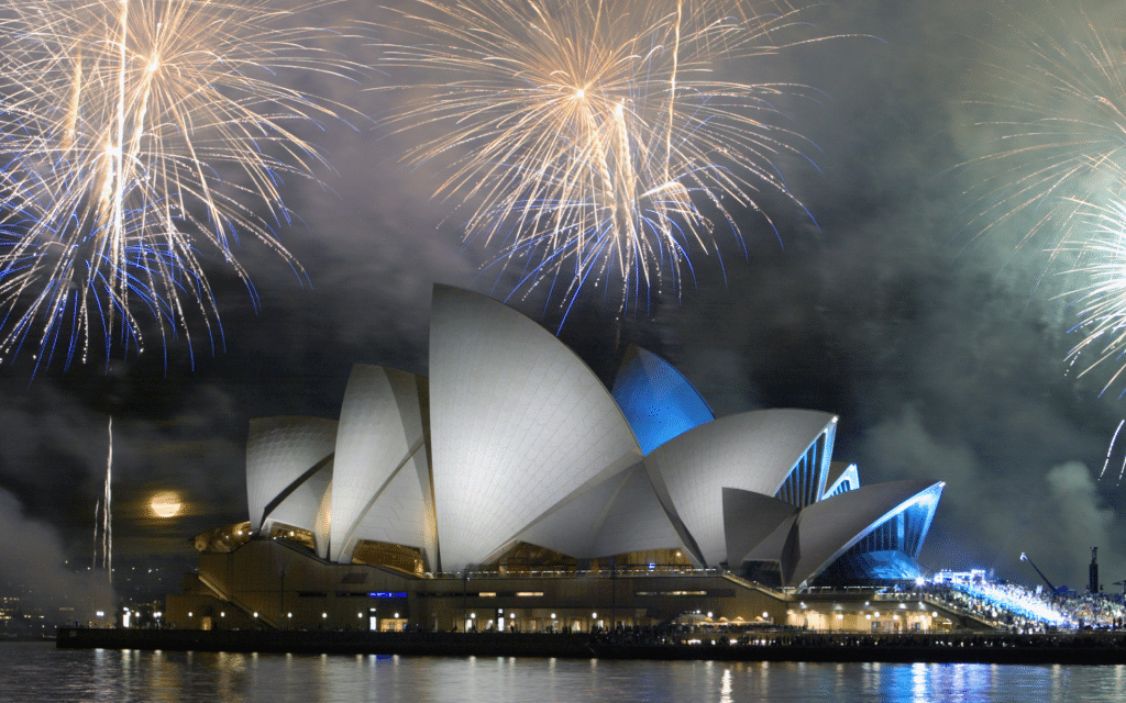 The Sydney Opera House with fireworks above. Want to capture the drama of a festive firework display? Then check out these 5 easy tips to photograph fireworks like the pros!