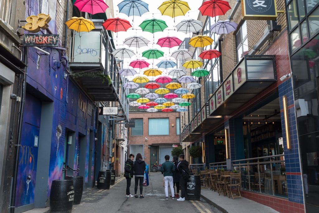 Colorful umbrellas hung over a street alley in Dublin. #UmbrellaStreet