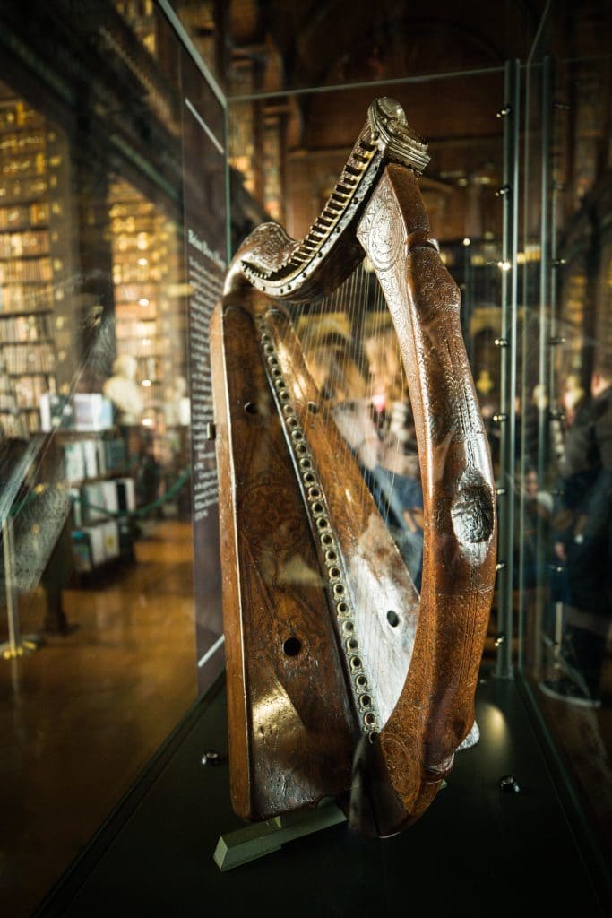 A wooden harp in a glass case. #LongRoom