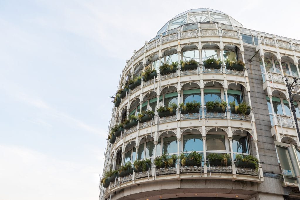 A round building exterior with planters in the window. #GraftonStreet