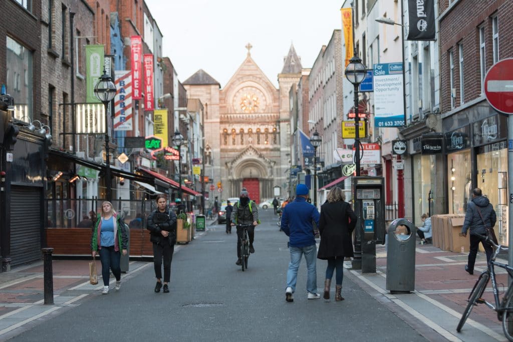 A sidestreet leading to a cathedral with a red door. #Dublin