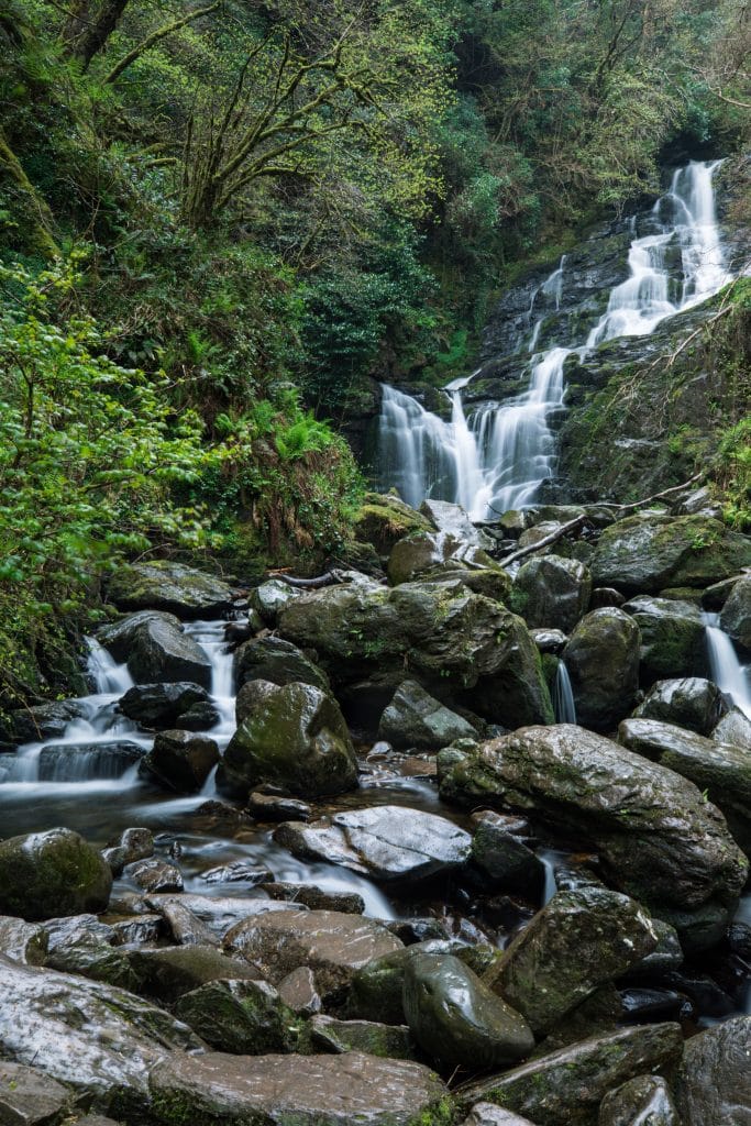 Torc waterfall surrounded by greenery. It's one of the most amazing things to see in Killarney! #TorcWaterfall #Killarney
