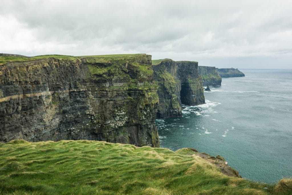 The green Cliffs of Moher. There are countless reasons to visit Ireland. Discover 8 of the most amazing places you really shouldn't miss on your next trip to the emerald isle!
