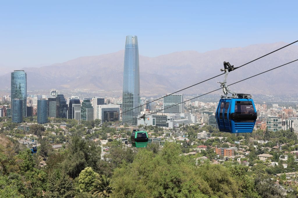 Red and green gondolas with Santiago, Chile in the background. #santiago #chile
