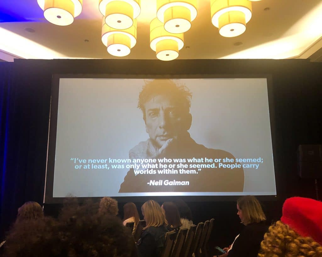 A portrait and quote on a presentation screen. #travelcon