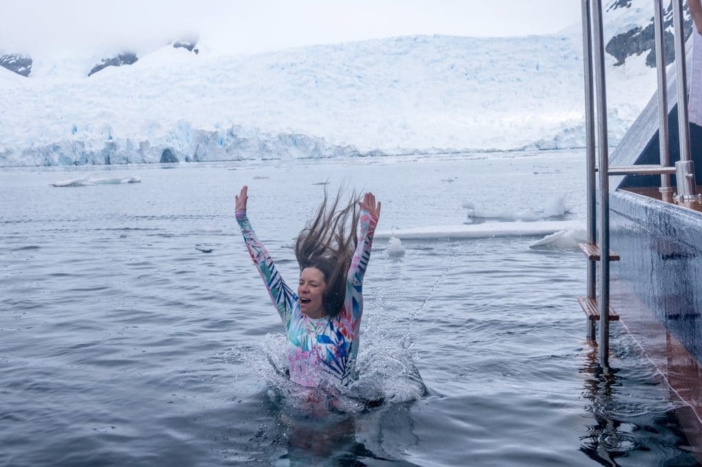 A girl jumping into the water in Antarctica. #antarctica