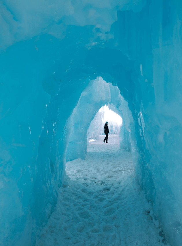 Person walking past an ice tunnel. One of the most picture perfect moments of 2019. #2019 #icecastle