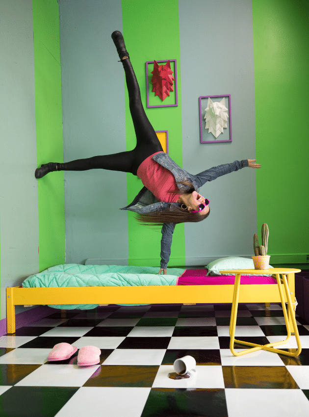 A girl cartwheeling upside down on a bed at the Selfie Museum in Denver. #selfiemuseum