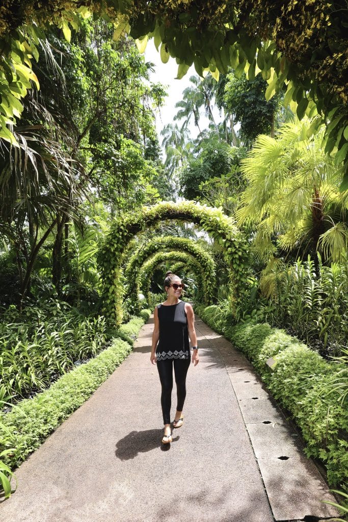 A girl walking down a garden path at the Singapore Botanic Gardens.