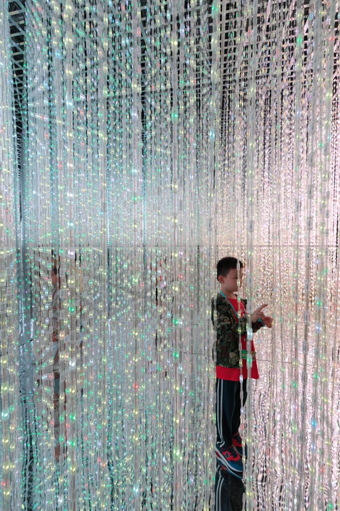 A young boy walking through crystal lights at the ArtScience Museum in Singapore. #singapore #artsciencemuseum