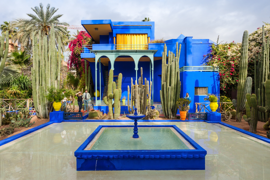 The blue facade of the main building in the Jardin Majorelle garden in Marrakesh. Discover the many alluring reasons to visit Marrakesh, Morocco. From must-see sights to can't-miss experiences, here's the very best of Marrakesh! #marrakesh #jardinmajorelle