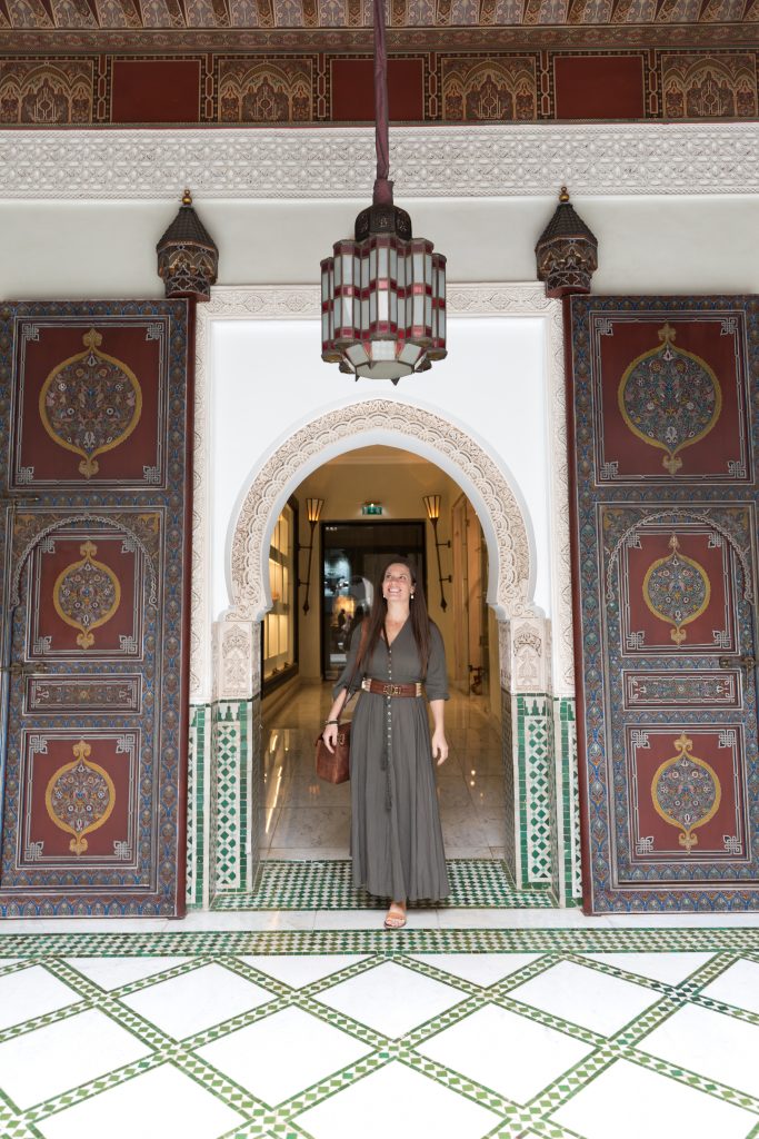 A girl walking through an elaborately decorated Moroccan doorway. #marrakesh #lamamounia