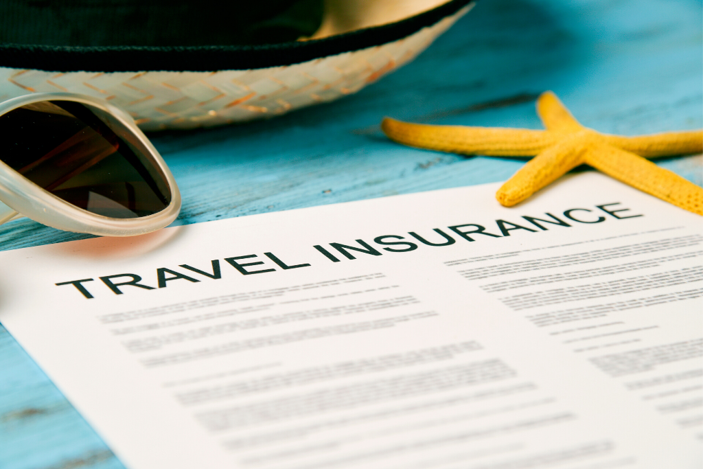 Travel insurance page lying next to a starfish and sunglasses. Discover why these 10 expert tips for staying healthy while traveling will make your jetsetting a whole lot more enjoyable! #travelhealth