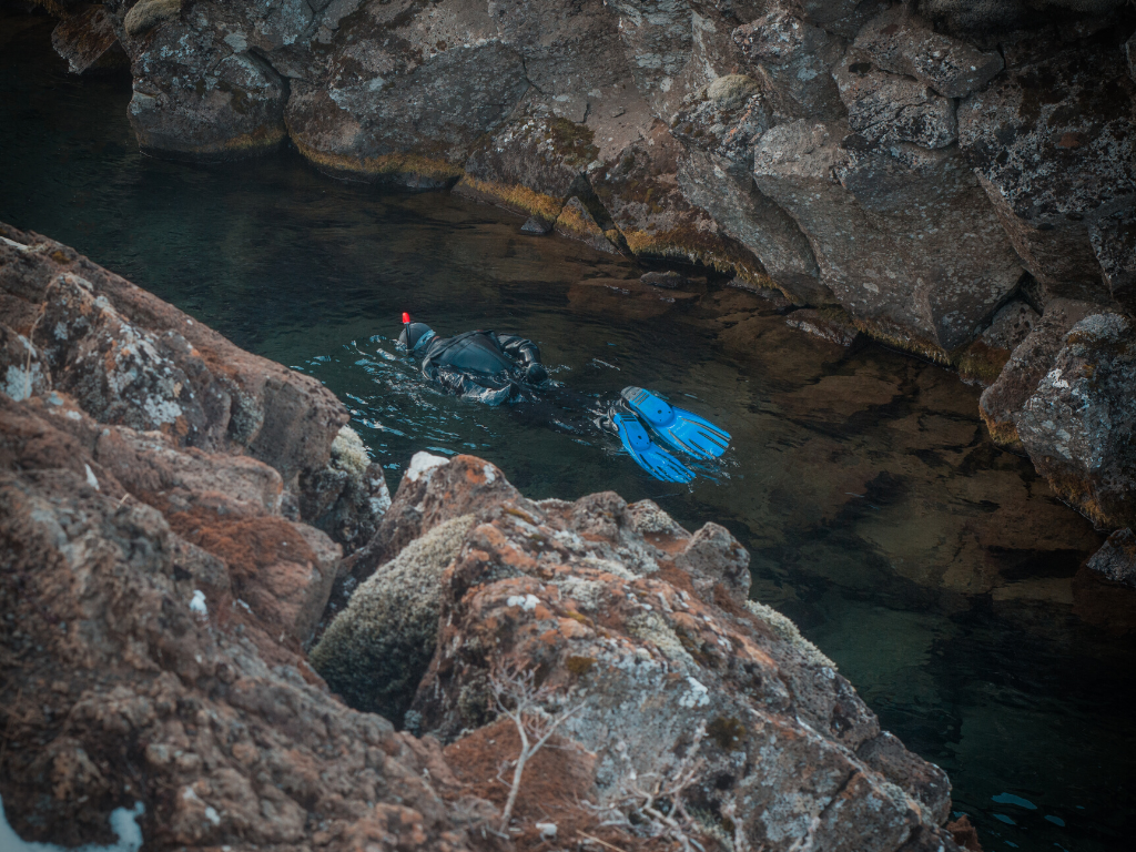 A person snorkeling between tectonic plates.