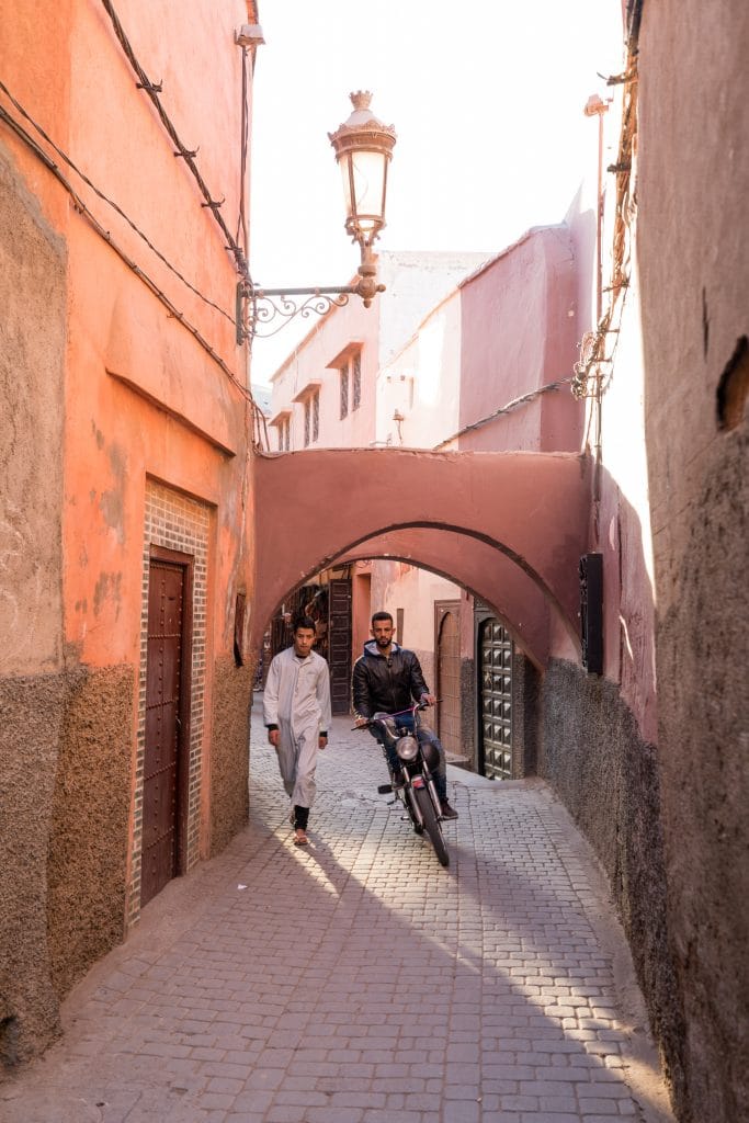 People walking and riding through the maze of streets in Marrakesh. #thingstoknowbeforevisitingmarrakesh